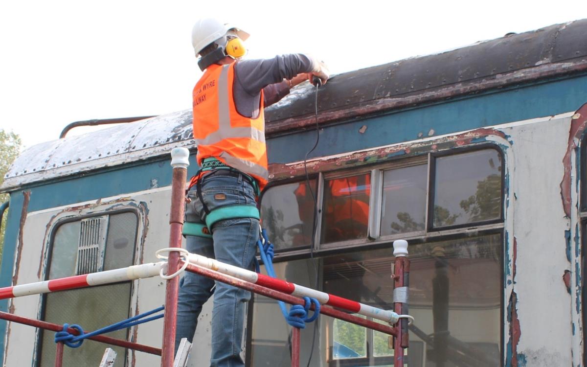 Preparing to paint the roof of the DMU.