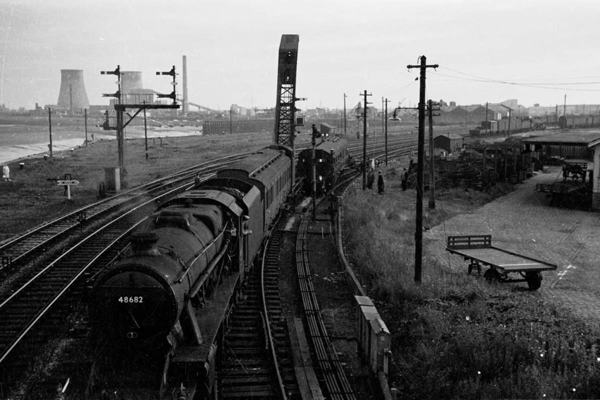 An LMS Stanier 8F 48682 outside Fleetwood Station, hauling a permanent way maintenance carriage and crane. © Copyright, Dave Schofield